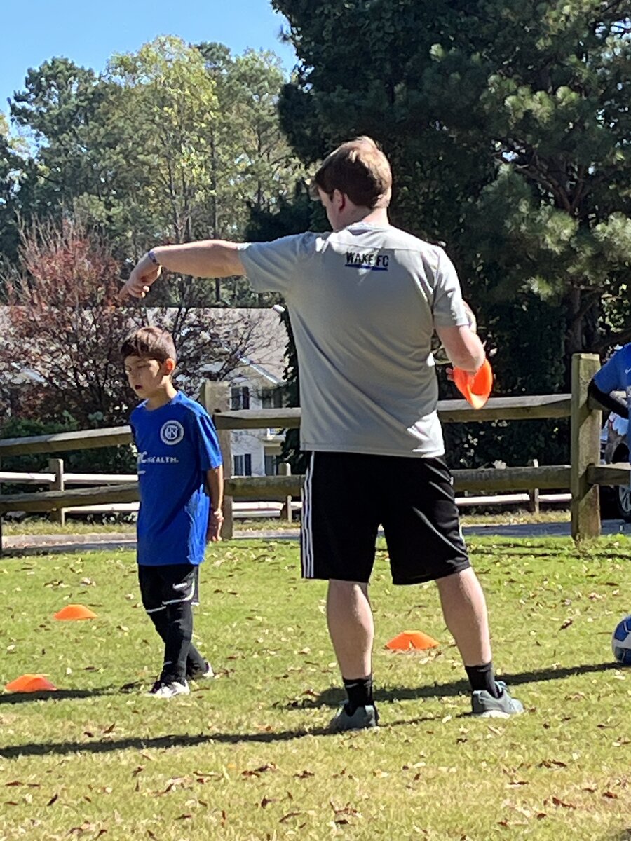 Coach Will directing a drill with cones